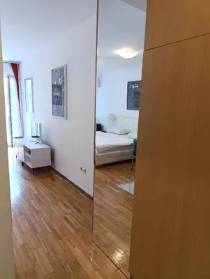 a mirror in a room with a bed and a bedroom at Kala in Belgrade