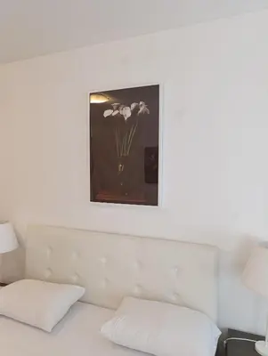 a vase of flowers sitting on top of a bed at Kala in Belgrade