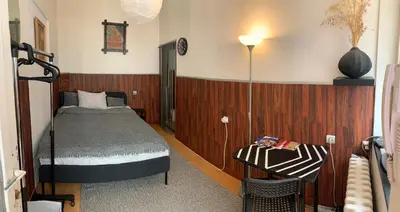 a bedroom with a bed and a table with a lamp at Apartment Little Oasis TASH in Belgrade