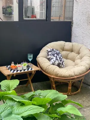 a couch sitting on a patio with a table at Apartment Little Oasis TASH in Belgrade