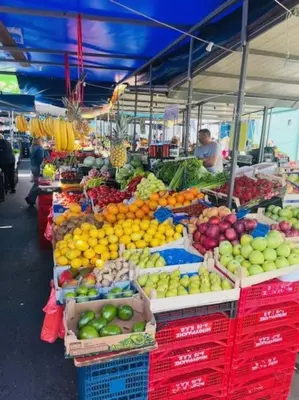 a market with many different fruits and vegetables on display at Lela's Place Vojvode Brane in Belgrade