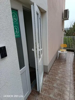 a door to a building with a sign on it at Udobna Soba Sa Prelepim Pogledom #4 in Mladenovac