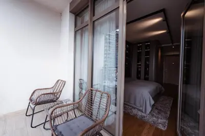 a room with two chairs and a bed and a window at inJoy in Sajmište