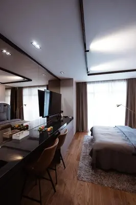a bedroom with a bed and a desk with a desk at inJoy in Sajmište