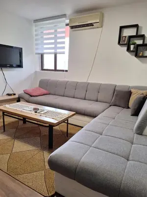 a living room with a couch and a coffee table at Kuća za odmor Sara in Čortanovci