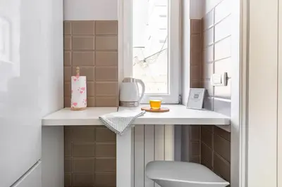 a small bathroom with a toilet and a window at 3 Steps from Center in Belgrade