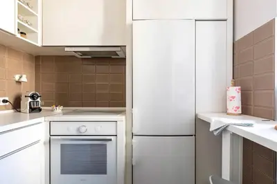 a kitchen with a white refrigerator and a stove at 3 Steps from Center in Belgrade