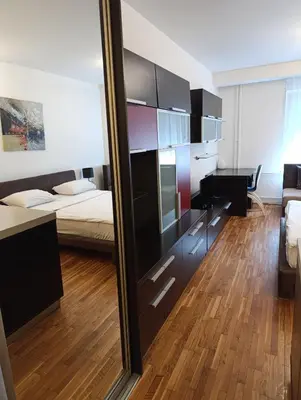 a mirror in a room with a bed and a bedroom at Iris Slavija in Sajmište