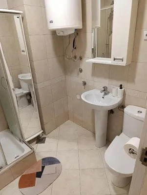 a small bathroom with a sink and a toilet at Iris Slavija in Sajmište