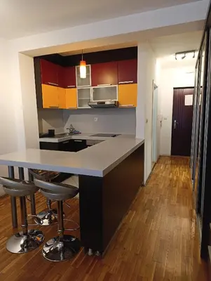 a kitchen with a island with bar stools at Iris Slavija in Sajmište