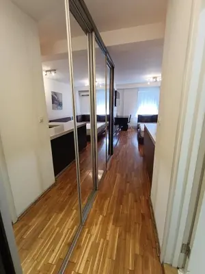 a room with a hallway with glass doors at Iris Slavija in Sajmište