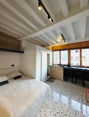 a bedroom with a bed and a sink and a desk at Central Studio 531- Pedestrian Zone Belgrade in Belgrade