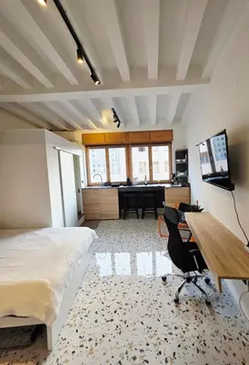a bedroom with a bed and a desk with a computer at Central Studio 531- Pedestrian Zone Belgrade in Belgrade