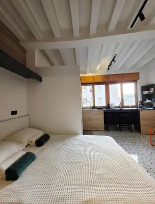 a bedroom with a large bed and a dining room at Central Studio 531- Pedestrian Zone Belgrade in Belgrade