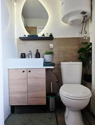 a bathroom with a toilet and a sink and a mirror at Central Studio 531- Pedestrian Zone Belgrade in Belgrade