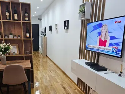 a living room with a flat screen tv on a wall at Ada mall-Beograd 2 bedroom in Čukarica