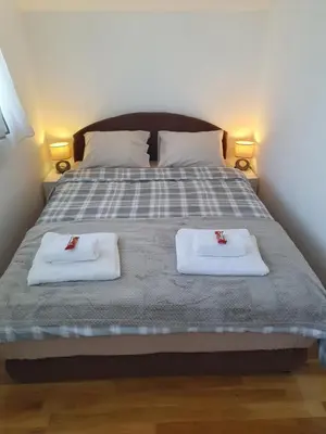 a bedroom with a bed with two towels on it at Ada mall-Beograd 2 bedroom in Čukarica