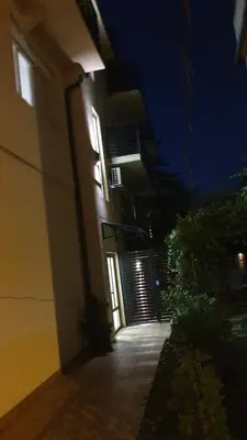a building with a hallway leading to a door at night at Ada mall-Beograd 2 bedroom in Čukarica