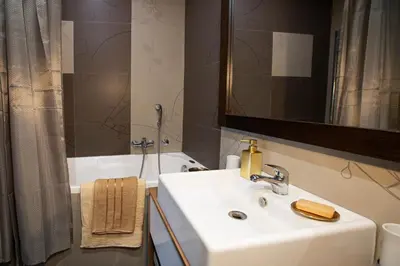 a bathroom with a sink and a mirror and a tub at Goldy in Belgrade