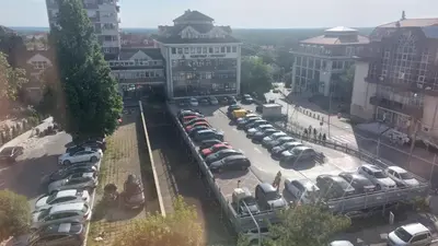 an aerial view of a parking lot with cars at apartman Ada mall in Čukarica