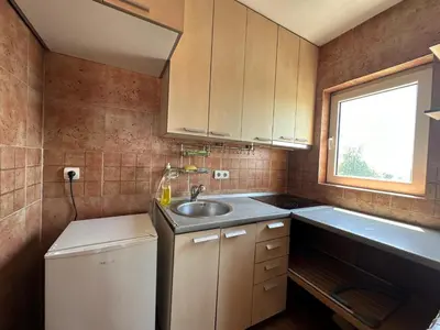 a small kitchen with a sink and a window at apartman Ada mall in Čukarica