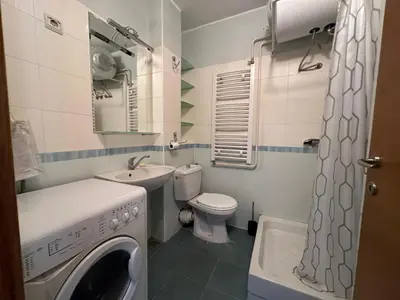 a small bathroom with a washing machine in it at apartman Ada mall in Čukarica