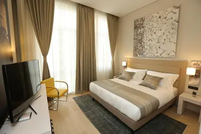 a bedroom with a bed and a flat screen tv at Zepter Hotel Belgrade, member of Zepter Hotels in Belgrade