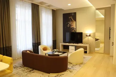 a living room with a couch and chairs and a television at Zepter Hotel Belgrade, member of Zepter Hotels in Belgrade