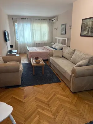 a living room with a couch and a table at Apartments Sat in Belgrade