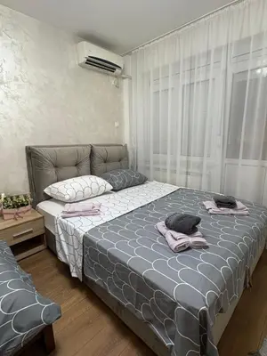 a bedroom with a bed with two towels on it at Apartments Sat in Belgrade