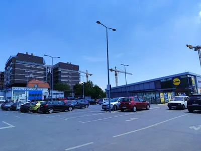 a parking lot with a lot of cars parked at Apartments Jedro in Belgrade