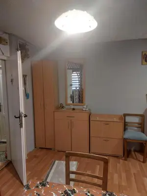 a room with a kitchen with a light on the ceiling at apartman Milica in Ruma