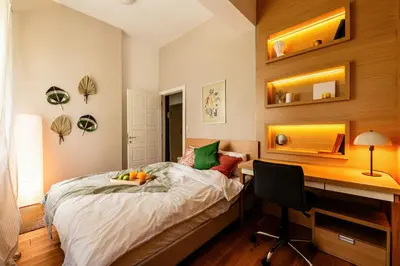 a bedroom with a desk and a bed with a bowl of fruit on it at Grand Gallery with Cinema & Balcony Old Town in Belgrade