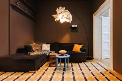 a living room with a black couch and a table at Grand Gallery with Cinema & Balcony Old Town in Belgrade