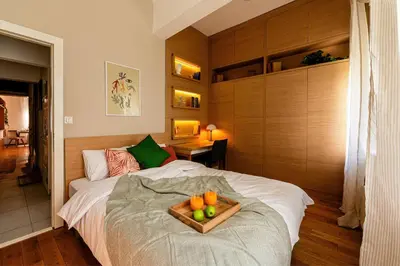 a bedroom with a bed with a tray of fruit on it at Grand Gallery with Cinema & Balcony Old Town in Belgrade