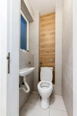 a bathroom with a toilet and a sink at Grand Gallery with Cinema & Balcony Old Town in Belgrade