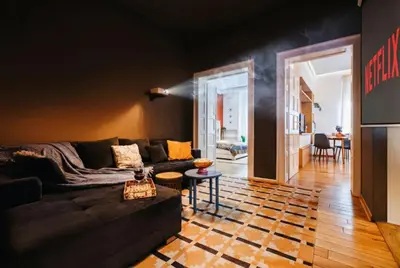 a living room with a couch and a checkered floor at Grand Gallery with Cinema & Balcony Old Town in Belgrade