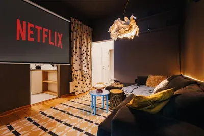 a living room with a couch and a tv at Grand Gallery with Cinema & Balcony Old Town in Belgrade