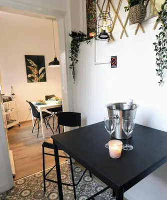 a table with wine glasses and a candle on it at Apartment Maria Belgrade Residence in Vračar (historical)