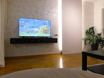 a living room with a flat screen tv on a wall at Apartment Maria Belgrade Residence in Vračar (historical)