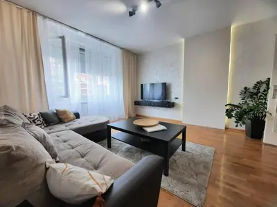 a living room with a couch and a table at Apartment Maria Belgrade Residence in Vračar (historical)