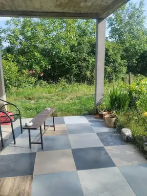 a table and a bench on a checkered patio at Villa Salter in Belgrade