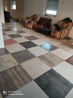 a living room with two chairs and a checkered floor at Villa Salter in Belgrade