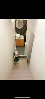 a staircase leading to a bathroom with a sink at Lovely one bedroom apartment in Belgrade