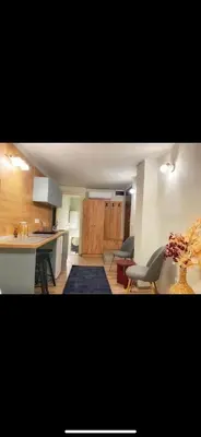 a kitchen with a table and chairs in a room at Lovely one bedroom apartment in Belgrade