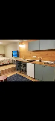 a kitchen with a desk and a sink and a bed at Lovely one bedroom apartment in Belgrade