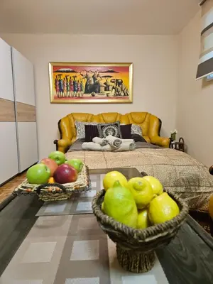 a bedroom with a bed and a basket of apples at Narnia in Belgrade