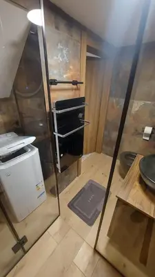 a room with a kitchen with a glass wall at Narnia in Belgrade