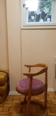 a wooden chair with a purple seat in front of a window at Narnia in Belgrade