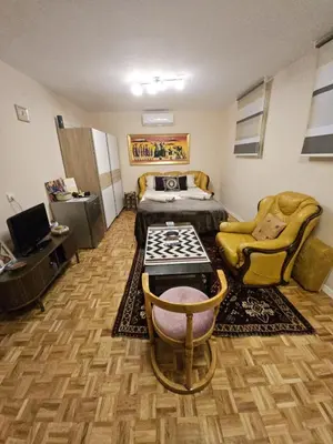 a room with a bedroom with a bed and a desk at Narnia in Belgrade